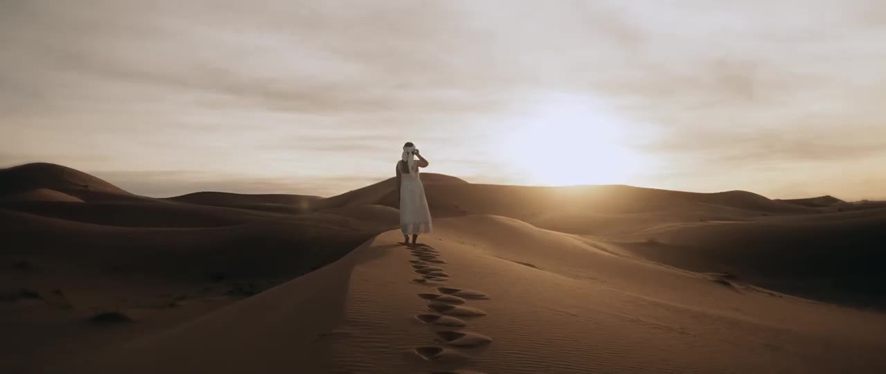 A traveller on the dunes at sunset in the Moroccan Sahara