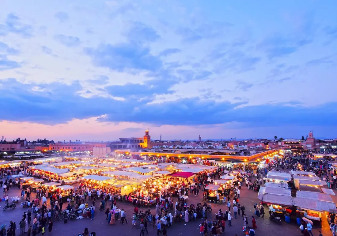 The Jemaa el-Fna square lit up at dusk in Marrakech