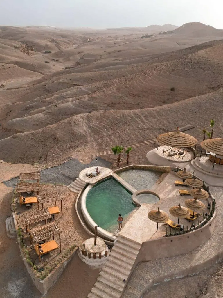A pool and lounge tents at a luxury Agafay desert camp
